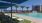 a pool with chairs and umbrellas by it